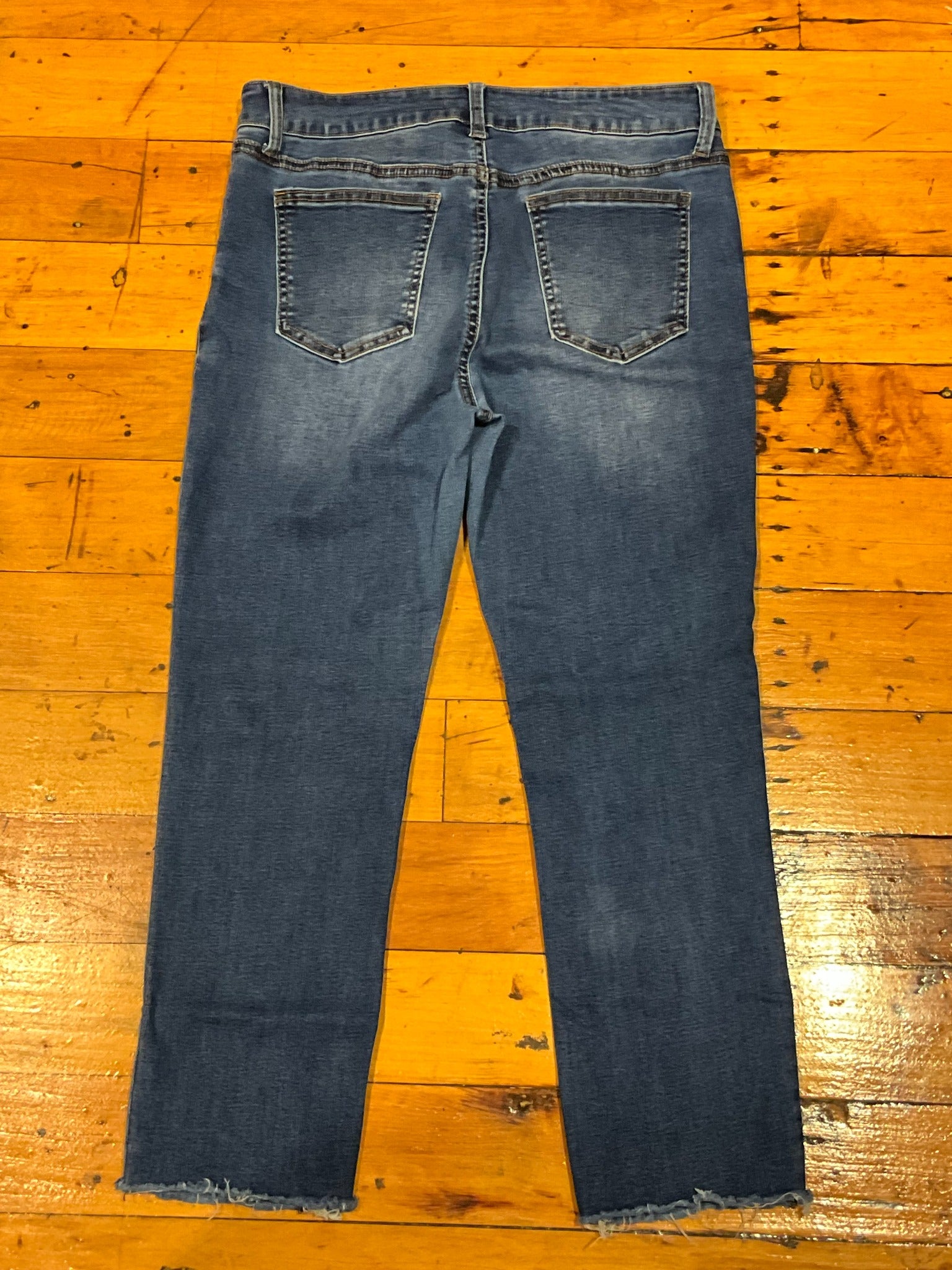 Fire and Rain women's medium wash flare jeans back view with raw hems